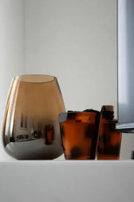 a lamp and two glasses sitting on a shelf at Aura Apartment - Lovely Apartment with Garage Parking in Belgrade