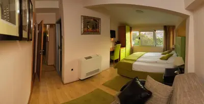 a hotel room with a bed and a couch at Bed & Breakfast Garden40 in Belgrade