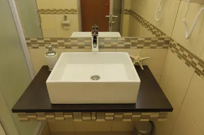 a bathroom with a white sink and a mirror at Bed & Breakfast Garden40 in Belgrade
