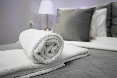 a pile of towels sitting on top of a bed at Bed & Breakfast Garden40 in Belgrade