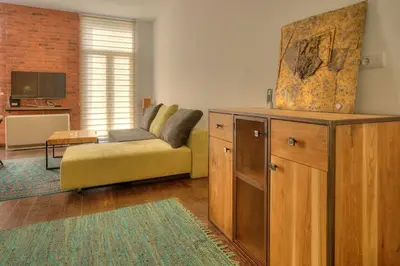 a living room with a couch and a tv at Knez Central Apartment in Belgrade