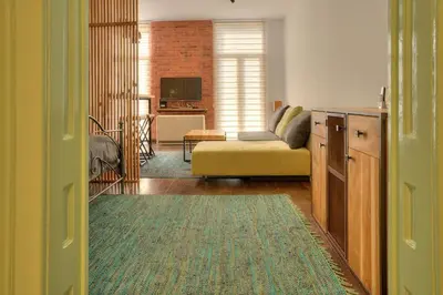 a living room with a couch and a table at Knez Central Apartment in Belgrade