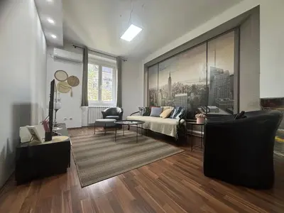 a living room with a bed and a couch at Mina 1 in Belgrade