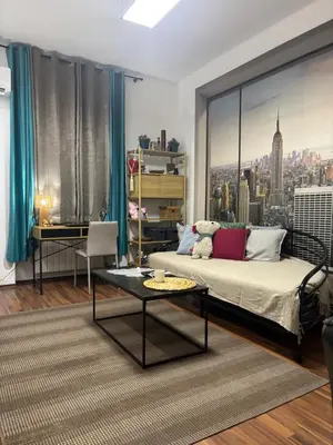 a bedroom with a bed and a view of a city at Mina 1 in Belgrade