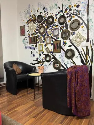 a living room with a tree mural on the wall at Mina 1 in Belgrade