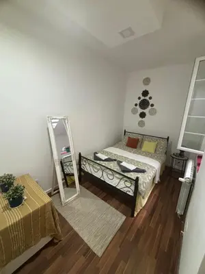 a small bedroom with a mirror and a bed at Mina 1 in Belgrade