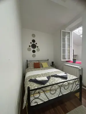 a bedroom with a bed and a window at Mina 1 in Belgrade
