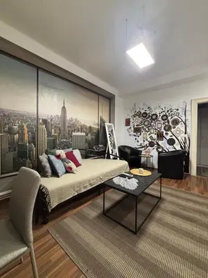 a bedroom with a bed and a large window at Mina 1 in Belgrade