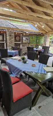 an outdoor patio with a table and chairs at Etno selo Dukat in Belo Polje
