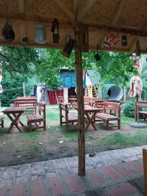 a group of picnic tables with a playground in the background at Etno selo Dukat in Belo Polje