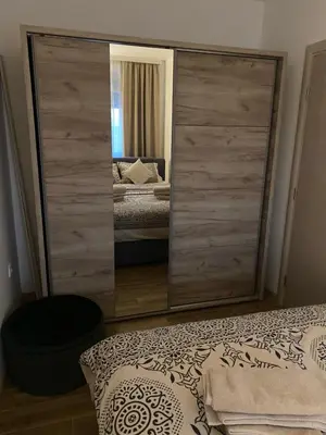 a large mirror in a bedroom with a bed at Green Lux Apartment in Inđija