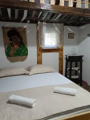 a bed with two pillows on it in a room at Etno selo Dukat in Belo Polje