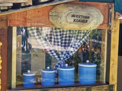 a display case with blue barrels in a window at Etno selo Dukat in Belo Polje