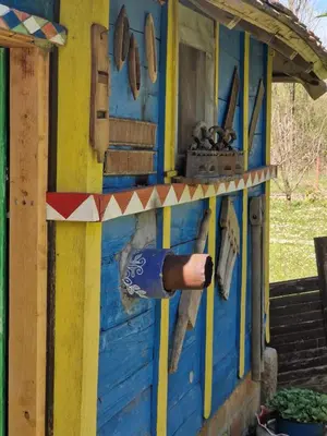 a man is standing inside of a play house at Etno selo Dukat in Belo Polje
