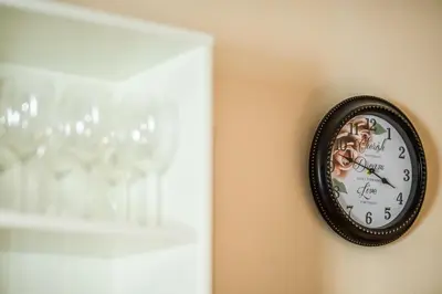 a clock on a wall next to a wine glass at Panorama Central-Downtown Studio in Belgrade