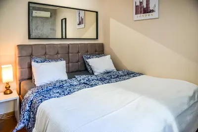 a bedroom with a bed and a mirror at Panorama Central-Downtown Studio in Belgrade
