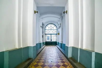 a hallway of a building with a window and a tile floor at Panorama Central-Downtown Studio in Belgrade