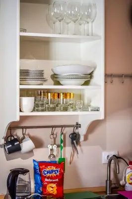 a kitchen cabinet with glasses and dishes on it at Panorama Central-Downtown Studio in Belgrade