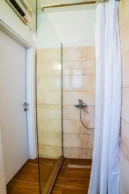 a shower with a glass door in a bathroom at Panorama Central-Downtown Studio in Belgrade