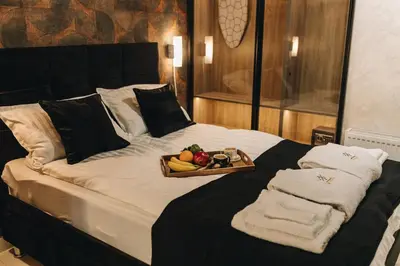 a bed with a tray of fruit on it at Apartman Premijer 2 in Čukarica
