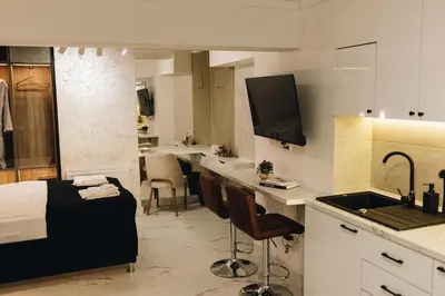a room with a bed and a kitchen with a sink at Apartman Premijer 2 in Čukarica