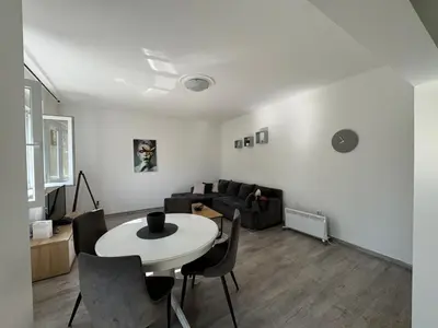 a living room with a table and a couch at KALEMEGDAN Apartment - Belgrade in Belgrade