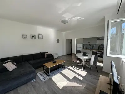 a living room with a black couch and a table at KALEMEGDAN Apartment - Belgrade in Belgrade