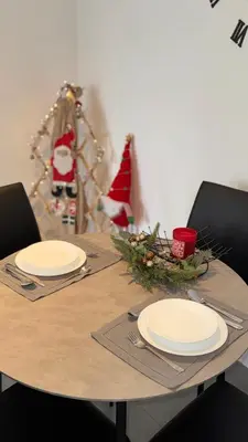 a table with two plates and a santa hat on it at LUNI Apartmants Vracar in Belgrade