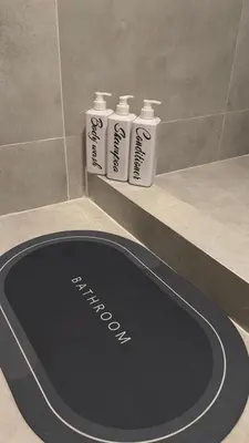 a bathroom counter with three bottles of shampoo at LUNI Apartmants Vracar in Belgrade
