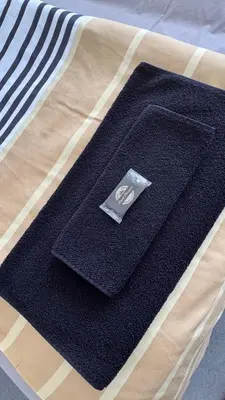 a black mat sitting on top of a bed at LUNI Apartmants Vracar in Belgrade