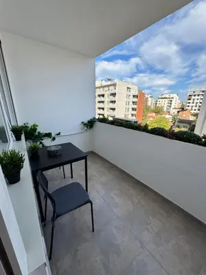 a balcony with a table and a view of a city at LUNI Apartmants Vracar in Belgrade