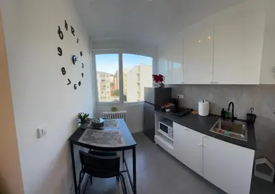 a small kitchen with a table and a counter at LUNI Apartmants Vracar in Belgrade