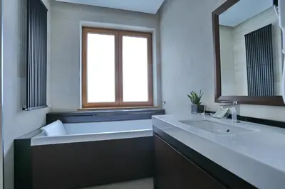 a bathroom with a sink and a large mirror at Belgreat Premium Suites in Belgrade