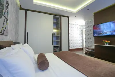 a bedroom with a bed with a flat screen tv at Belgreat Premium Suites in Belgrade