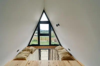 a room with a large window in a house at SunMoon Kosmaj kućice i prostor za događaje in Sopot