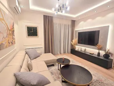 a living room with a couch and a flat screen tv at Premium Simfonija Apartment in Belgrade