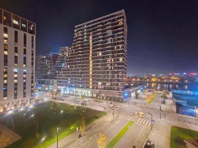 a city at night with a large tall building at Premium Simfonija Apartment in Belgrade