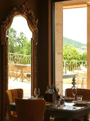 a dining room with a table and a mirror at Hyde Hill Kosmaj in Sopot