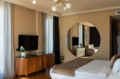 a bedroom with a bed and a large mirror at Hyde Hill Kosmaj in Sopot