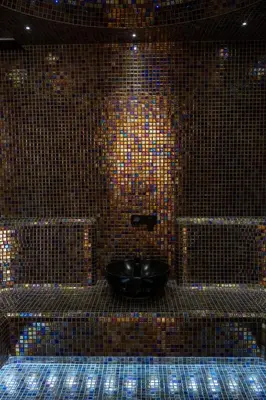 a bathroom with a black toilet in a tiled wall at Hyde Hill Kosmaj in Sopot
