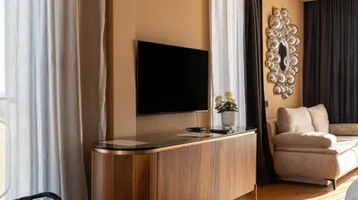a living room with a tv and a couch at Hyde Hill Kosmaj in Sopot