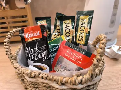a basket filled with snacks and books on a table at Apartman Viktor in Surčin