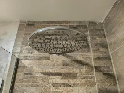 a bathroom with a metal toilet in the floor at Apartman Viktor in Surčin