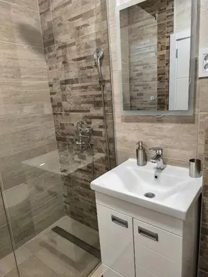 a bathroom with a sink and a shower at Apartman Viktor in Surčin