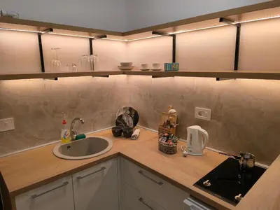a kitchen with a sink and a counter top with a sink at Apartman Viktor in Surčin