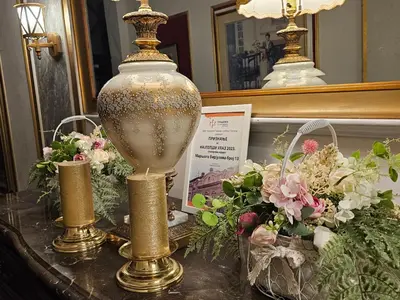a table with a large vase and flowers on it at VANSVEL Boutique Apartment 12 in Belgrade