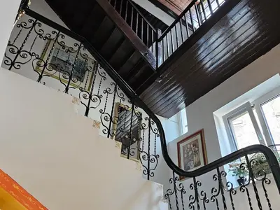 a staircase with wrought iron railings in a house at VANSVEL Boutique Apartment 12 in Belgrade