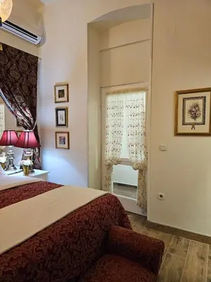 a bedroom with a large bed and a window at VANSVEL Boutique Apartment 12 in Belgrade