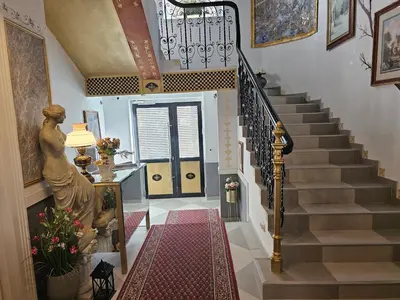 a staircase in a home with a statue of a woman at VANSVEL Boutique Apartment 12 in Belgrade
