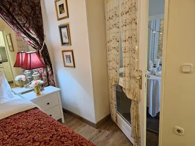 a bedroom with a bed and a dresser and a window at VANSVEL Boutique Apartment 12 in Belgrade
